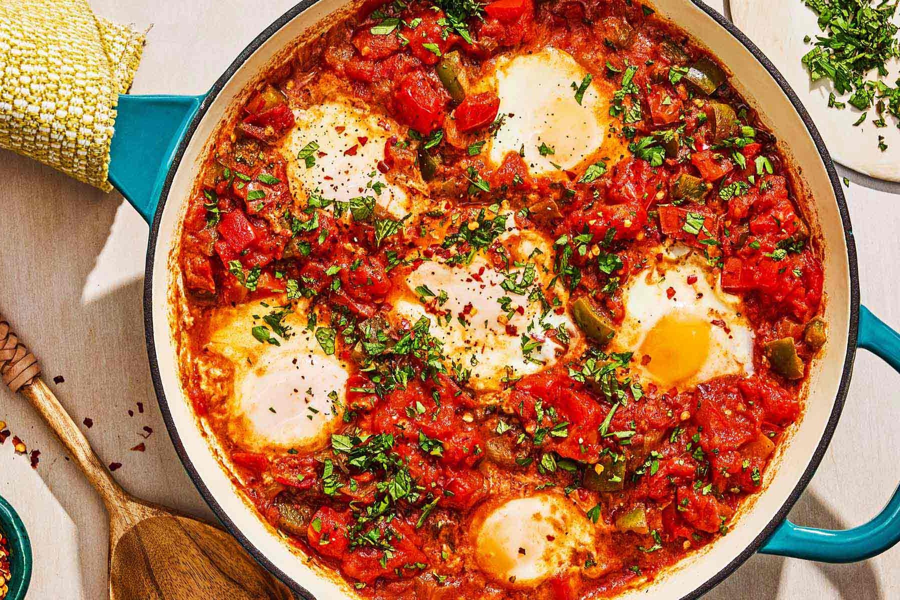 Eggs in shakshuka sauce wells