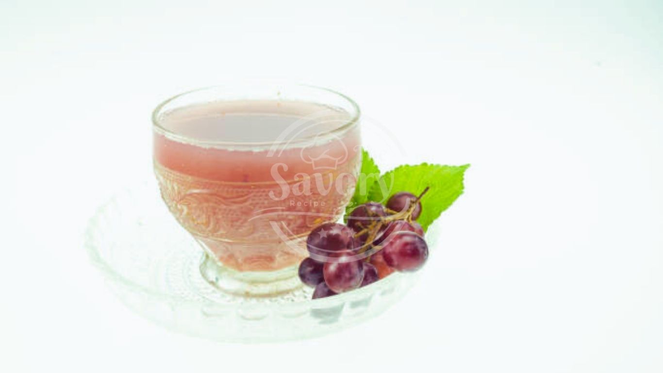 Overhead view of grape juice with fresh grapes