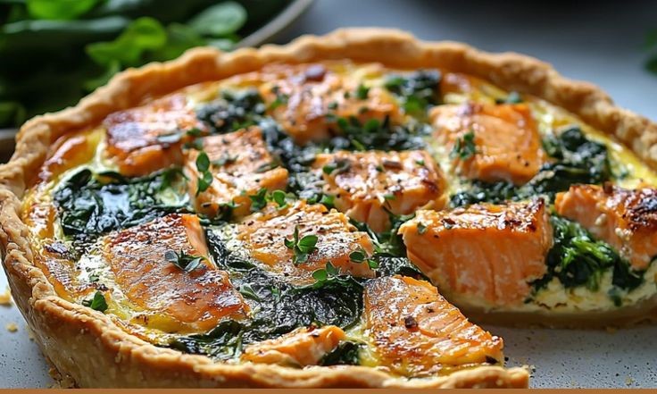 Salmon and spinach layered in quiche crust
